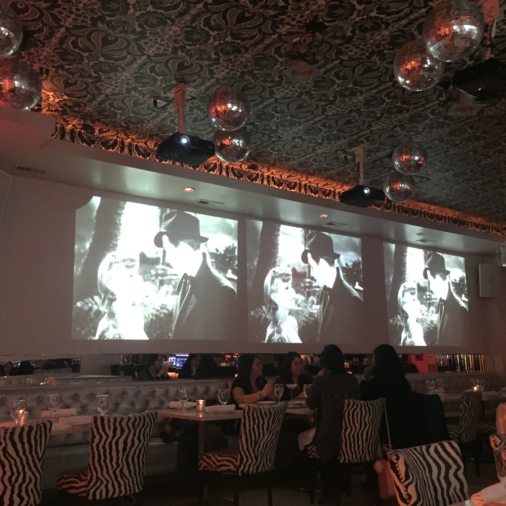 Three projectors playing vintage movies at Chicago venue